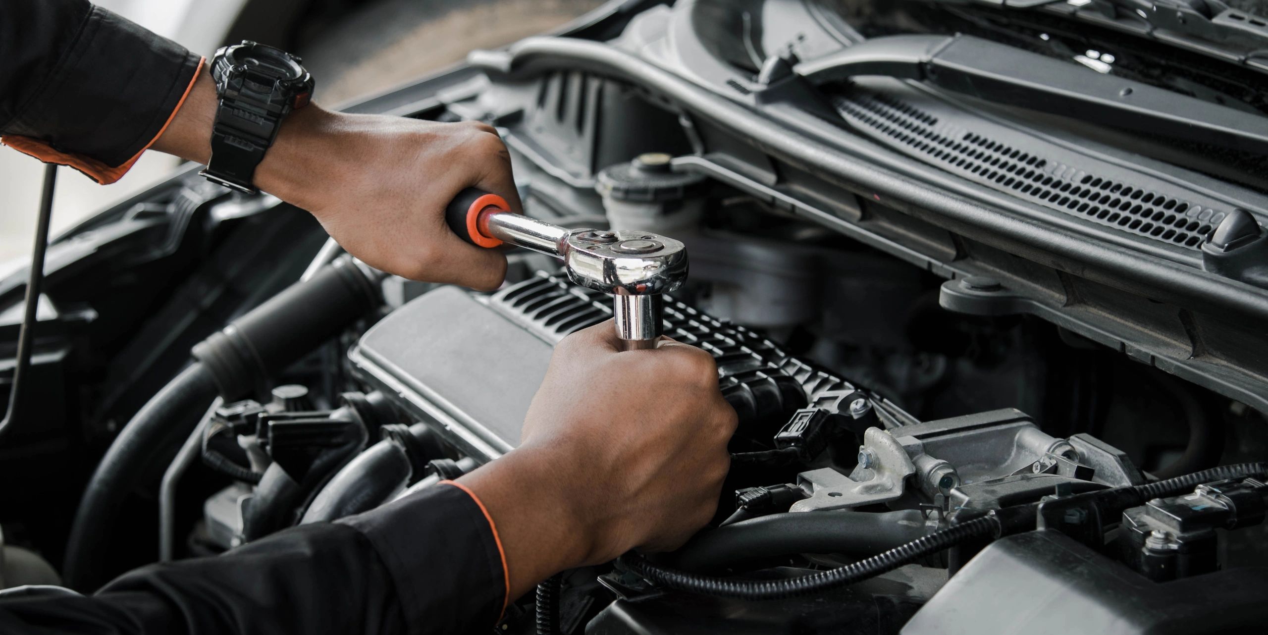 Mechanic working on a vehicle engine